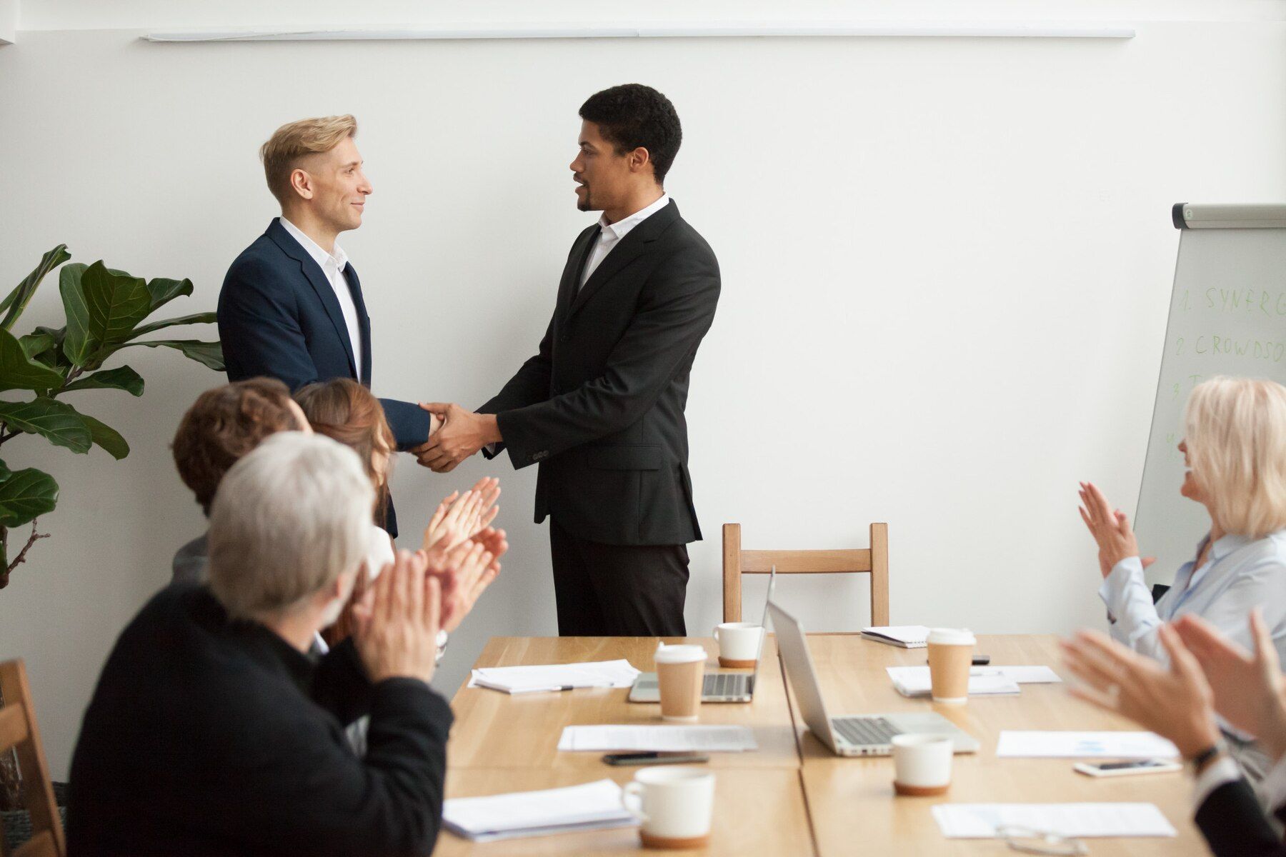 black-ceo-white-businessman-shaking-hands-group-meeting_1163-4885.jpg